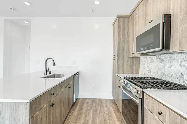 a kitchen with a sink and a stove top oven