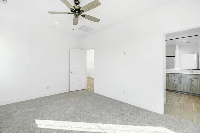 a view of a room with a ceiling fan
