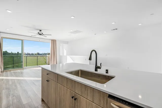 a kitchen with a sink and a large window