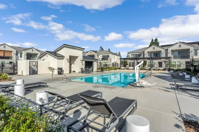 a view of a patio with table and chairs and potted plants