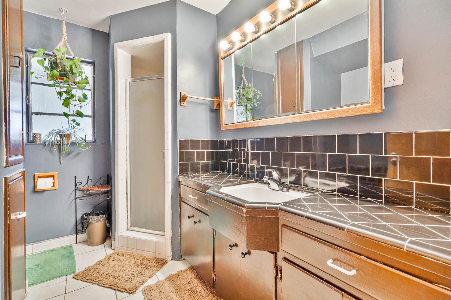 3852 East Washington Avenue Fresno, CA 93702 - Photo 12 of 30 a bathroom with a sink and a mirror