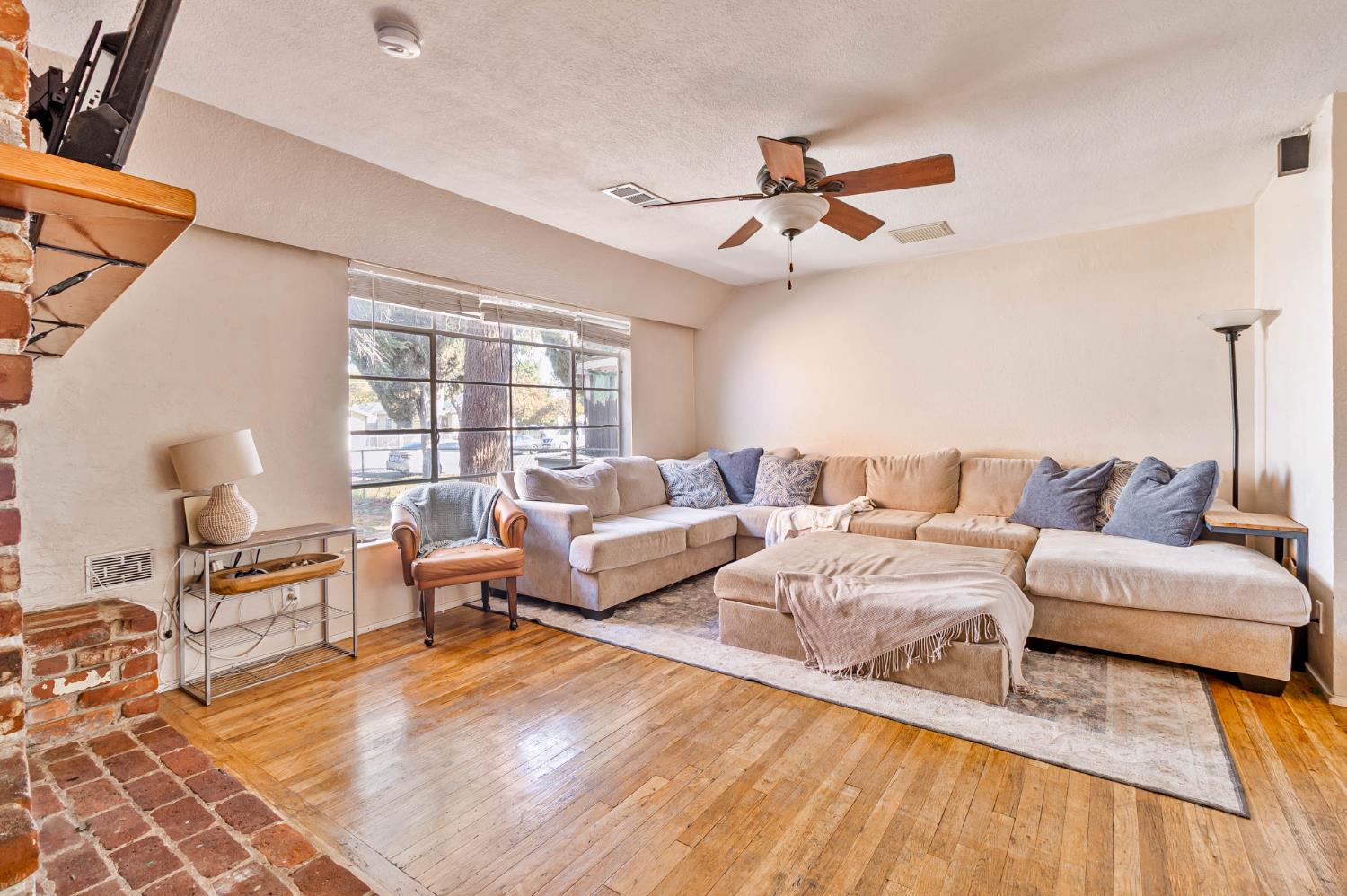 3852 East Washington Avenue Fresno, CA 93702 - Photo 2 of 30 a living room with furniture and a large window