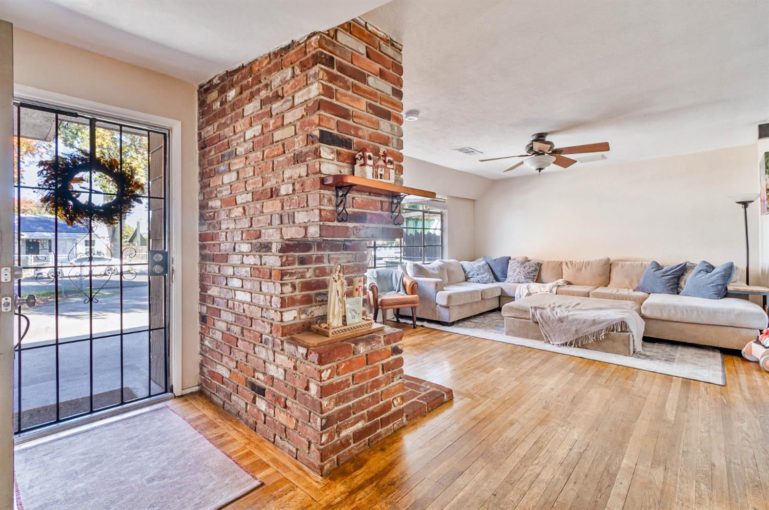 3852 East Washington Avenue Fresno, CA 93702 - Photo 6 of 30 a living room with furniture and wooden floor