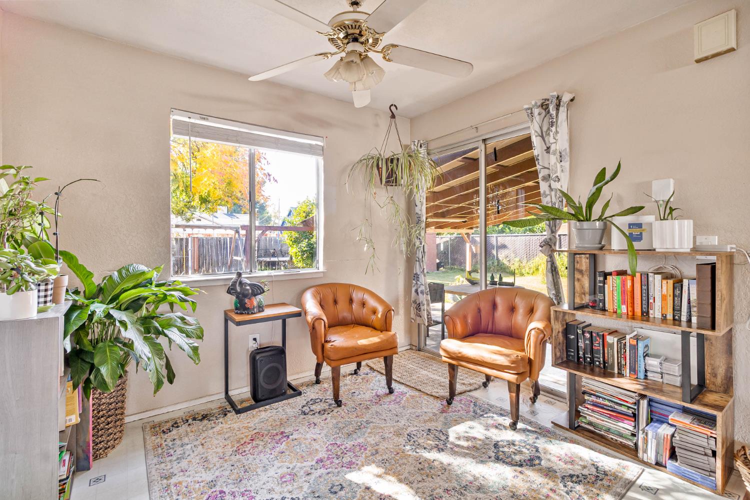 3852 East Washington Avenue Fresno, CA 93702 - Photo 9 of 30 a living room with furniture a bookshelf and a window