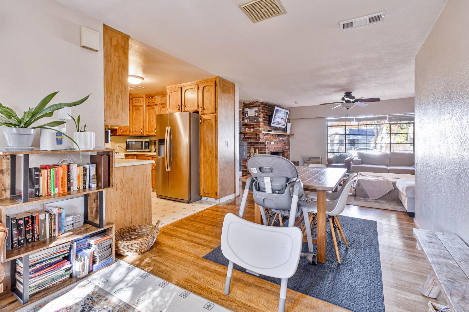 3852 East Washington Avenue Fresno, CA 93702 - Photo 10 of 30 a living room with furniture and a book shelf