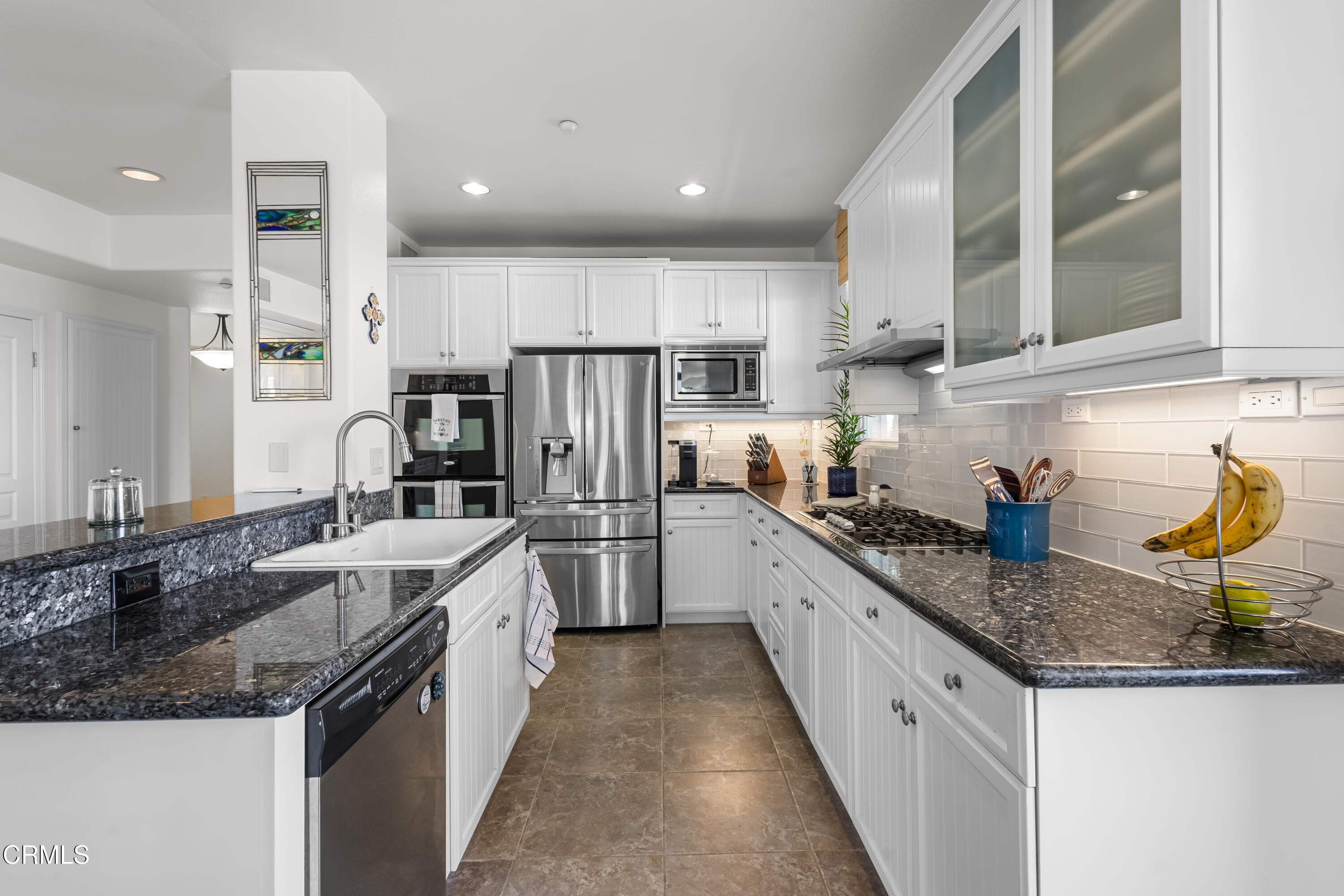 1536 Seabridge Lane Oxnard, CA 93035 - Photo 19 of 38 a kitchen with stainless steel appliances granite countertop a sink refrigerator and cabinets