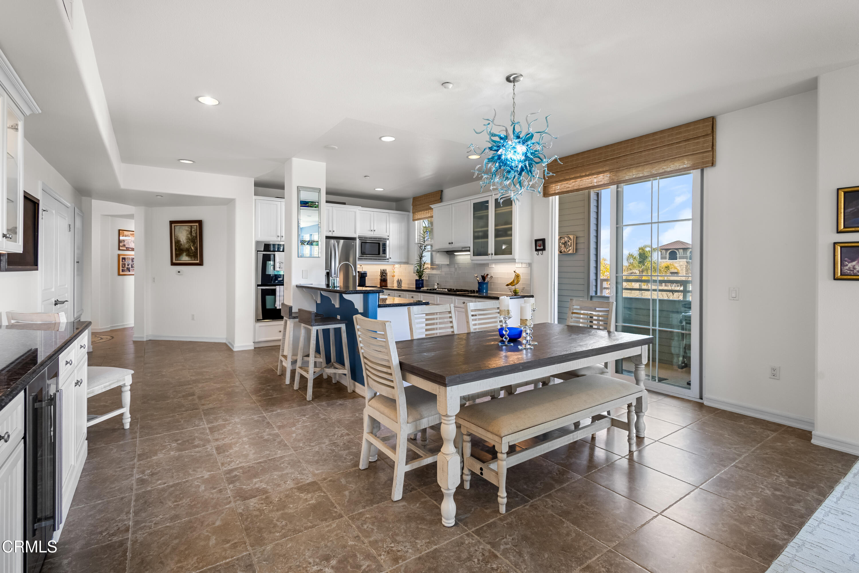 1536 Seabridge Lane Oxnard, CA 93035 - Photo 21 of 38 a view of a dining room with furniture and a chandelier