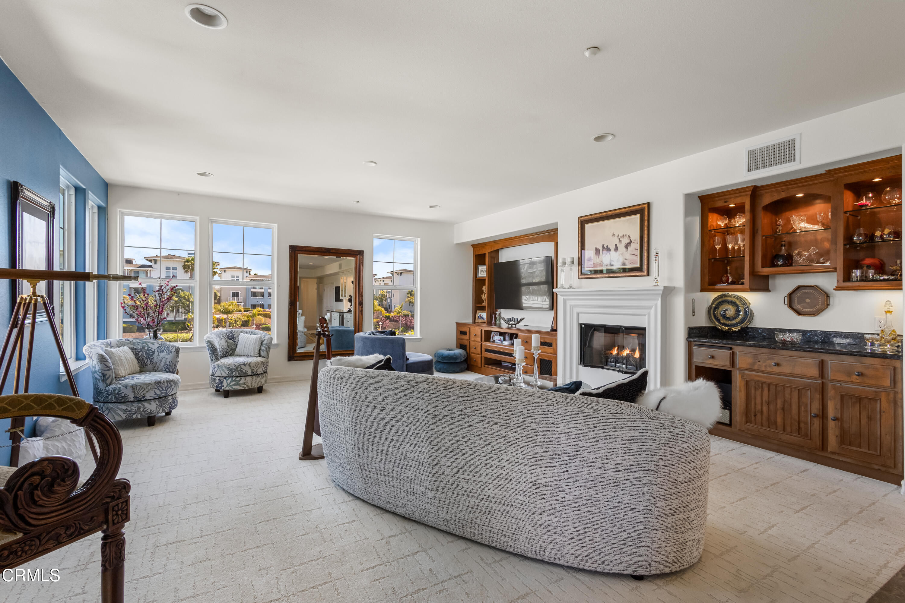 1536 Seabridge Lane Oxnard, CA 93035 - Photo 26 of 38 a living room with furniture a fireplace and a flat screen tv