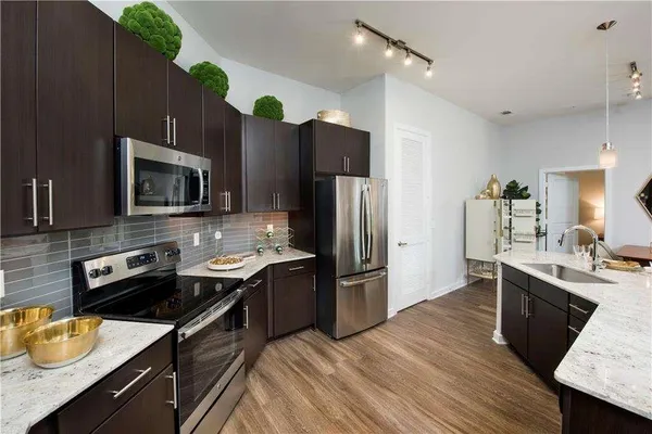 a kitchen with wooden cabinets and stainless steel appliances
