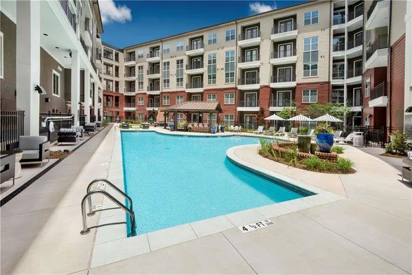 a building view with swimming pool and outdoor seating