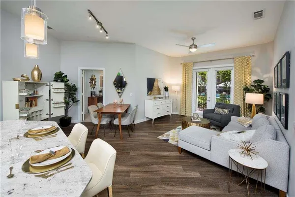 a living room with furniture and wooden floor