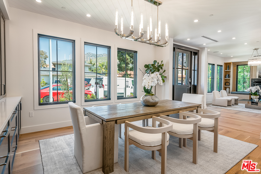 6310 Mirror Drive Los Angeles, CA 90068 - Photo 11 of 49 a dining room with furniture a chandelier and wooden floor