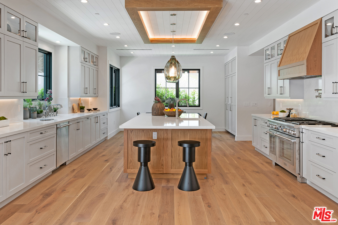 6310 Mirror Drive Los Angeles, CA 90068 - Photo 16 of 49 a kitchen with stainless steel appliances a table and chairs in it