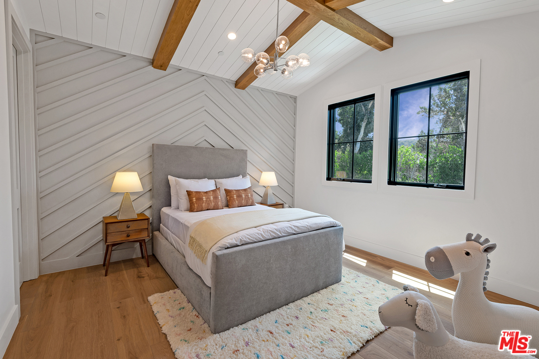 6310 Mirror Drive Los Angeles, CA 90068 - Photo 22 of 49 a bedroom with a bed and a lamp with window