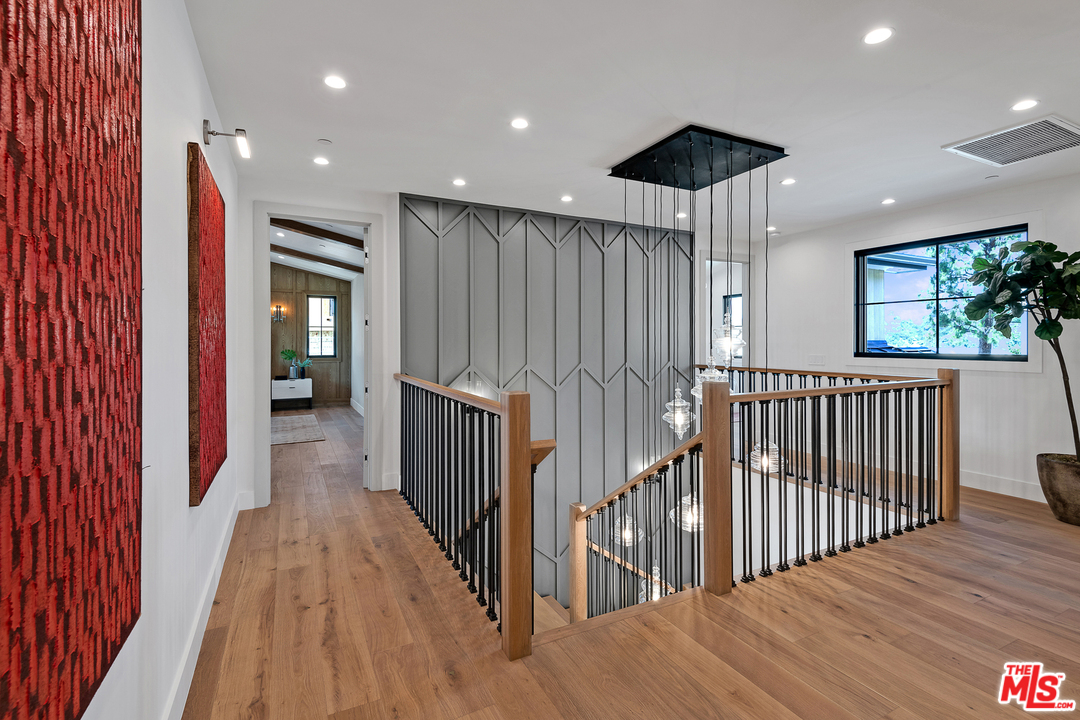 6310 Mirror Drive Los Angeles, CA 90068 - Photo 23 of 49 a view of a hallway with wooden floor and windows