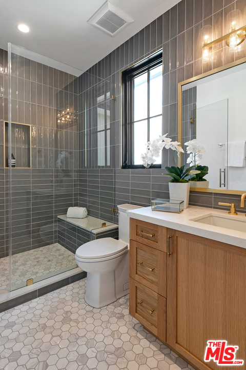 6310 Mirror Drive Los Angeles, CA 90068 - Photo 25 of 49 a bathroom with a toilet sink and mirror