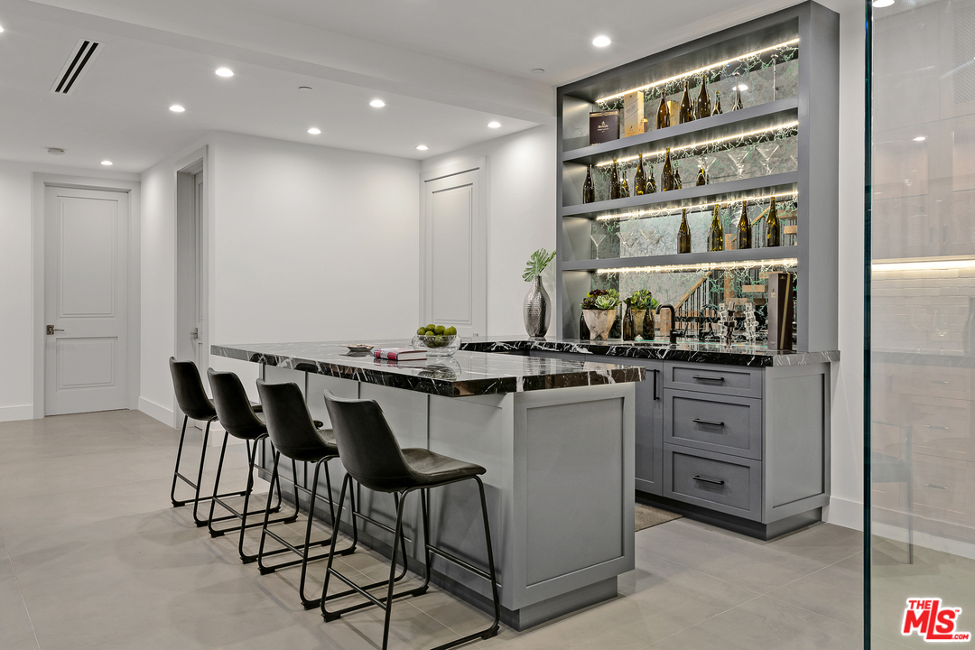 6310 Mirror Drive Los Angeles, CA 90068 - Photo 35 of 49 a kitchen with a dining table chairs cabinets and stainless steel appliances