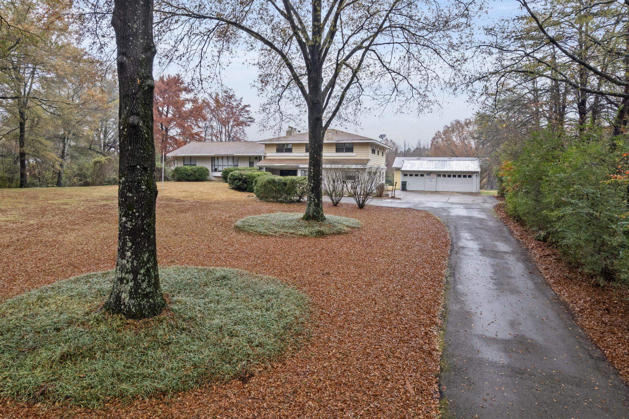 a sign board with yard in the back