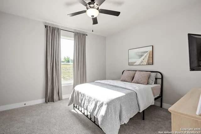 a spacious bedroom with a bed and a window