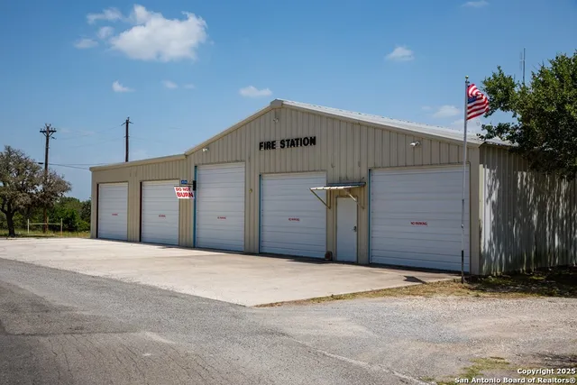 an aerial view of green landscape with trees houses and mountain view