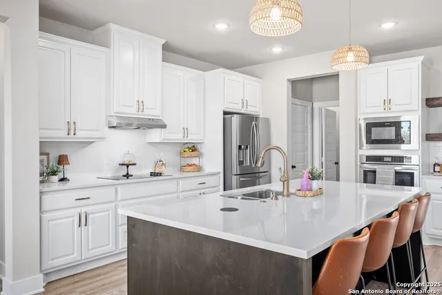 a kitchen with sink refrigerator and window