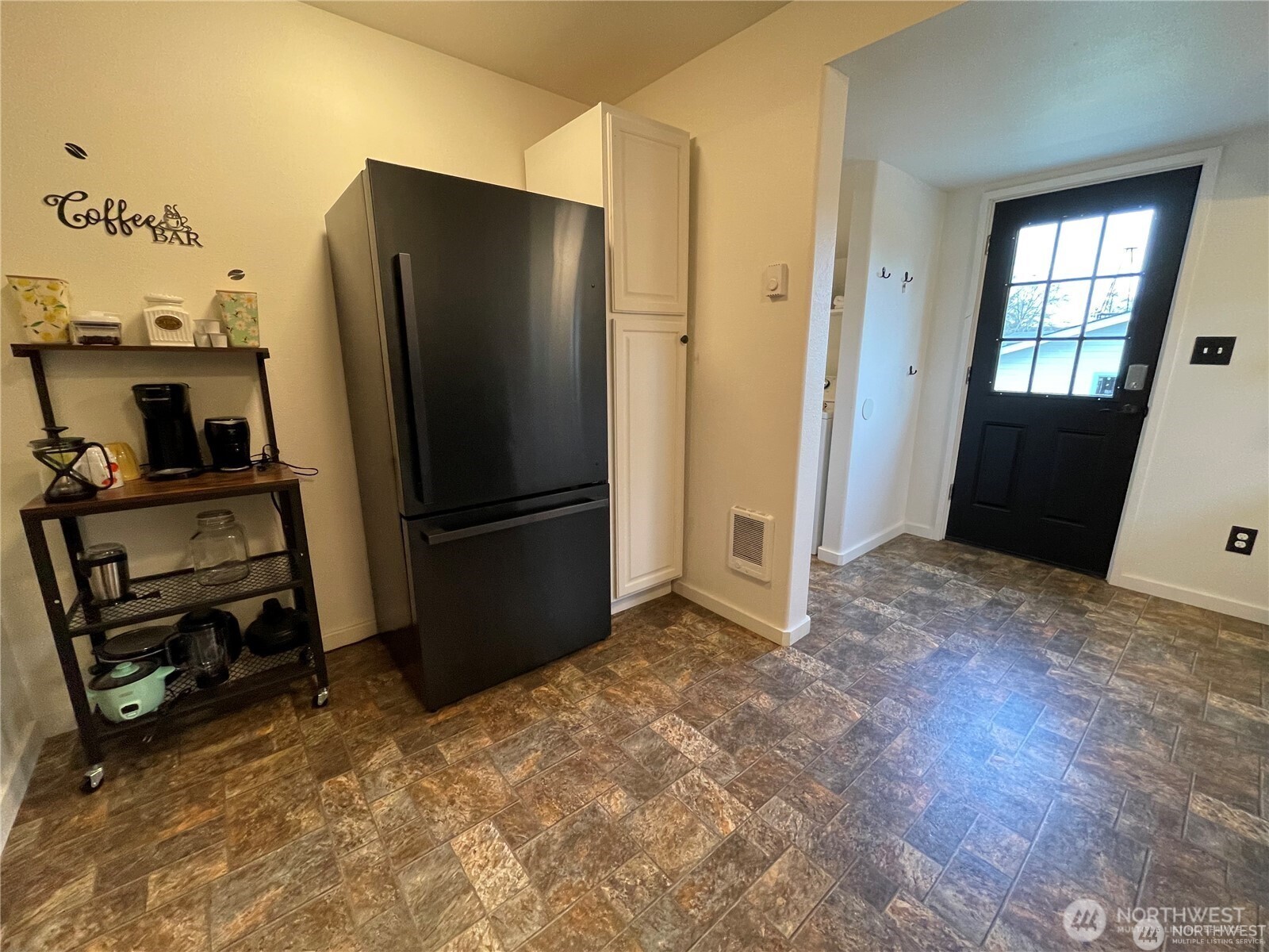 1707-1721 Fowler Road Raymond, WA 98577 - Photo 11 of 21 a view of a refrigerator in kitchen and an empty room