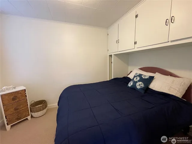 a bedroom with a bed and cabinets