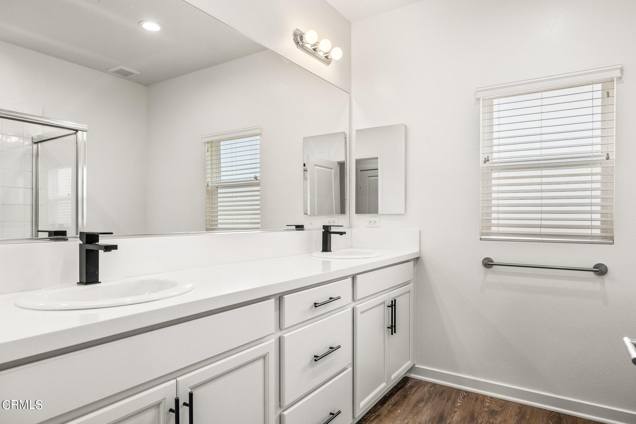 305 North F Street, Unit 201 Oxnard, CA 93030 - Photo 15 of 30 a bathroom with a double vanity sink and mirror