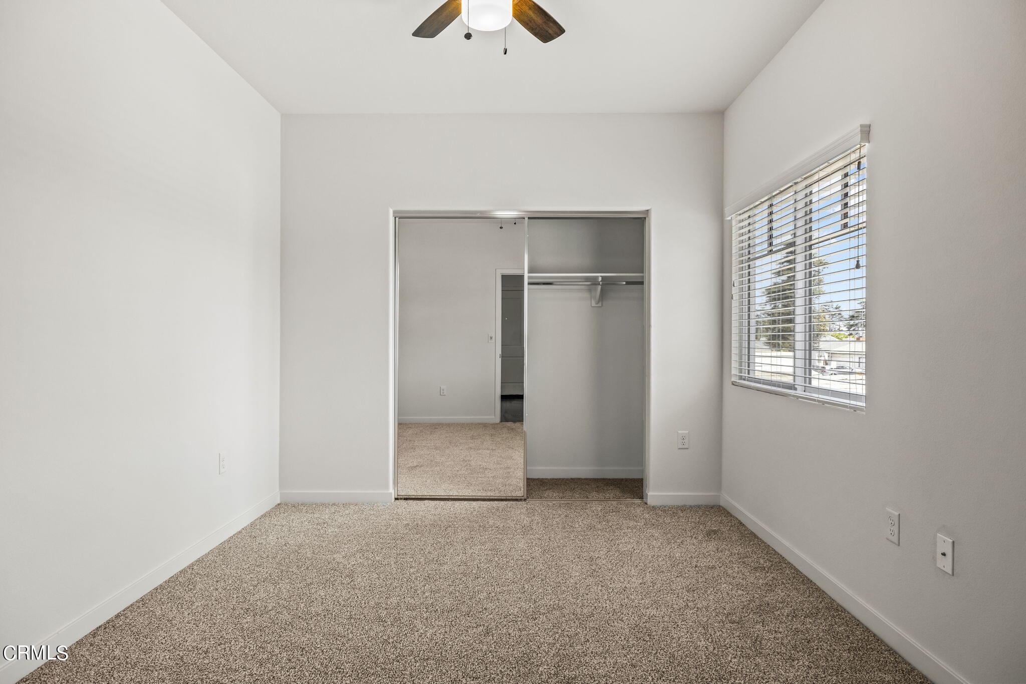 305 North F Street, Unit 201 Oxnard, CA 93030 - Photo 22 of 30 an empty room with closet and a chandelier fan