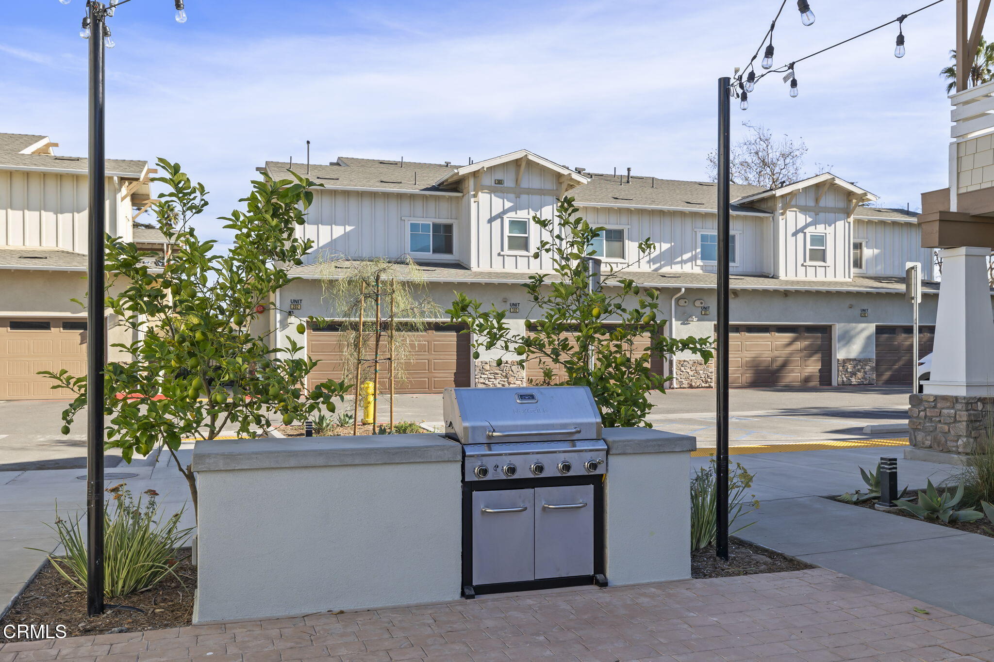 305 North F Street, Unit 201 Oxnard, CA 93030 - Photo 27 of 30 a view of a house with a yard and sitting area
