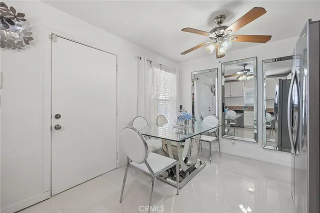 a view of a dining room with furniture and a chandelier fan