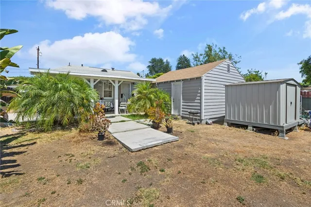 a view of a house with backyard and sitting area