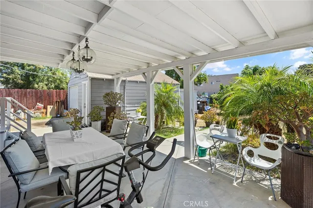 a view of a patio with table and chairs potted plants with wooden floor