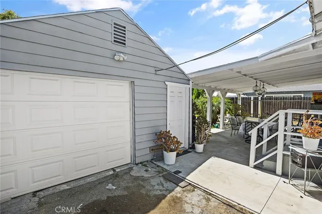 a view of a patio with table and chairs and potted plants