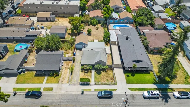 an aerial view of multiple houses with a yard