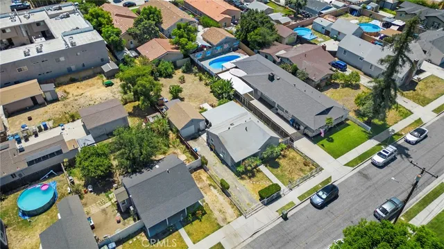 an aerial view of residential house with outdoor space and swimming pool