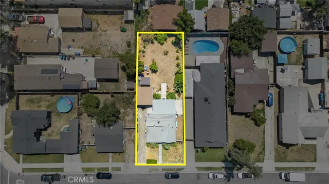 an aerial view of residential house with outdoor space and parking