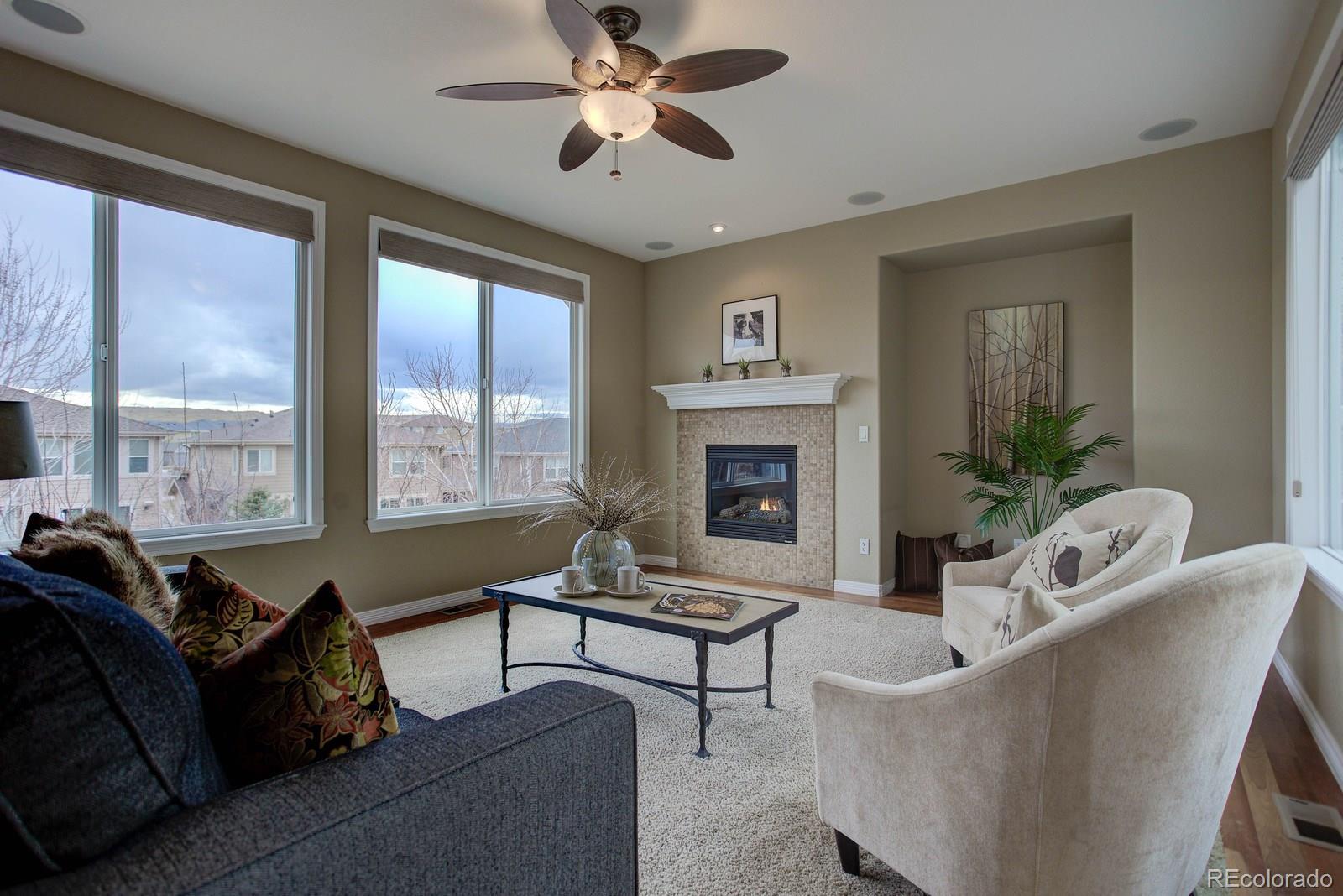 10879 Glengate Circle Highlands Ranch, CO 80130 - Photo 16 of 35 a living room with furniture and a fireplace