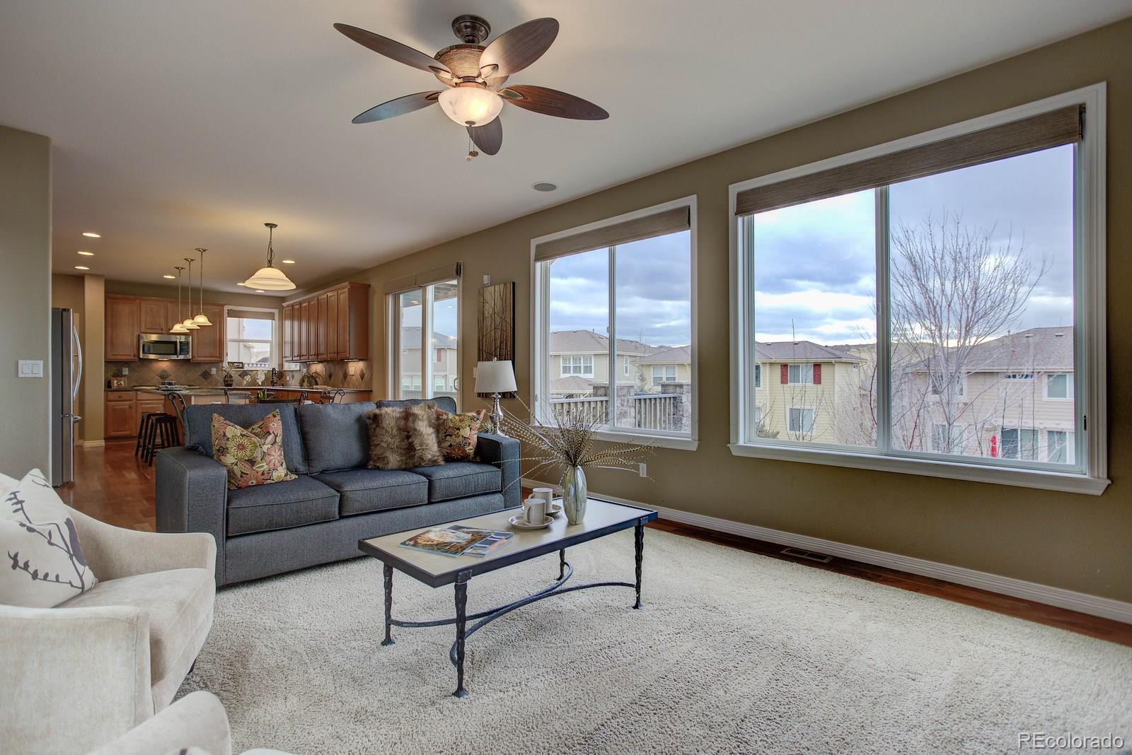 10879 Glengate Circle Highlands Ranch, CO 80130 - Photo 17 of 35 a living room with furniture and a large window