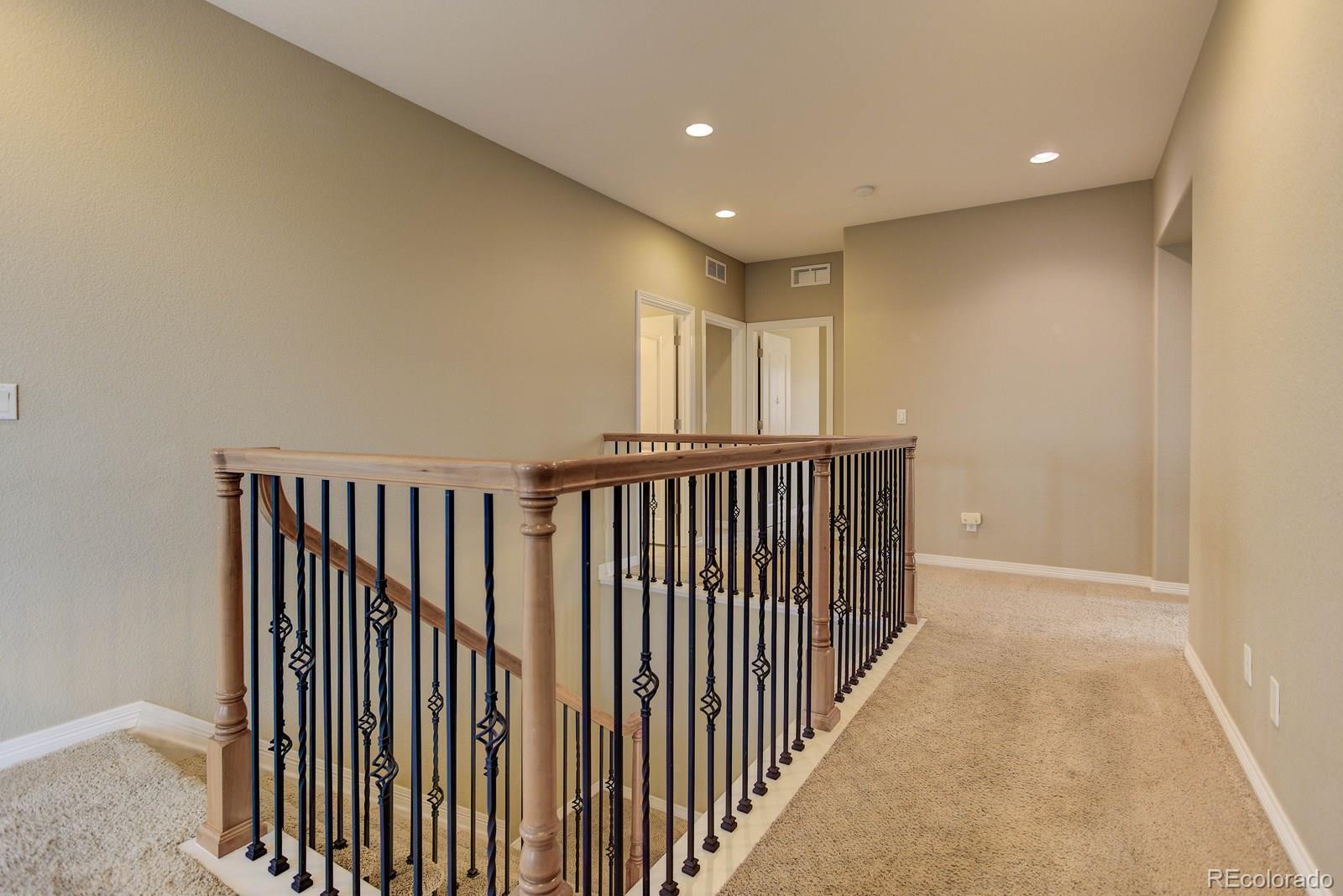 10879 Glengate Circle Highlands Ranch, CO 80130 - Photo 20 of 35 a view of a hallway with wooden floor
