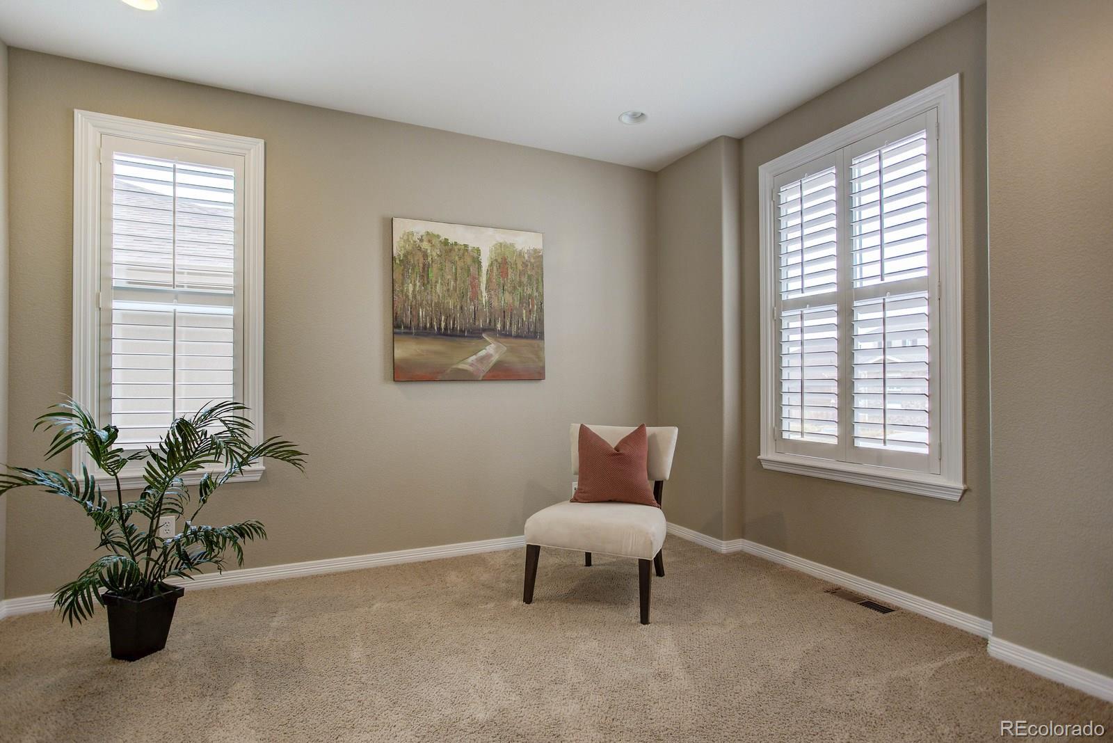 10879 Glengate Circle Highlands Ranch, CO 80130 - Photo 2 of 35 a living room with furniture and a potted plant