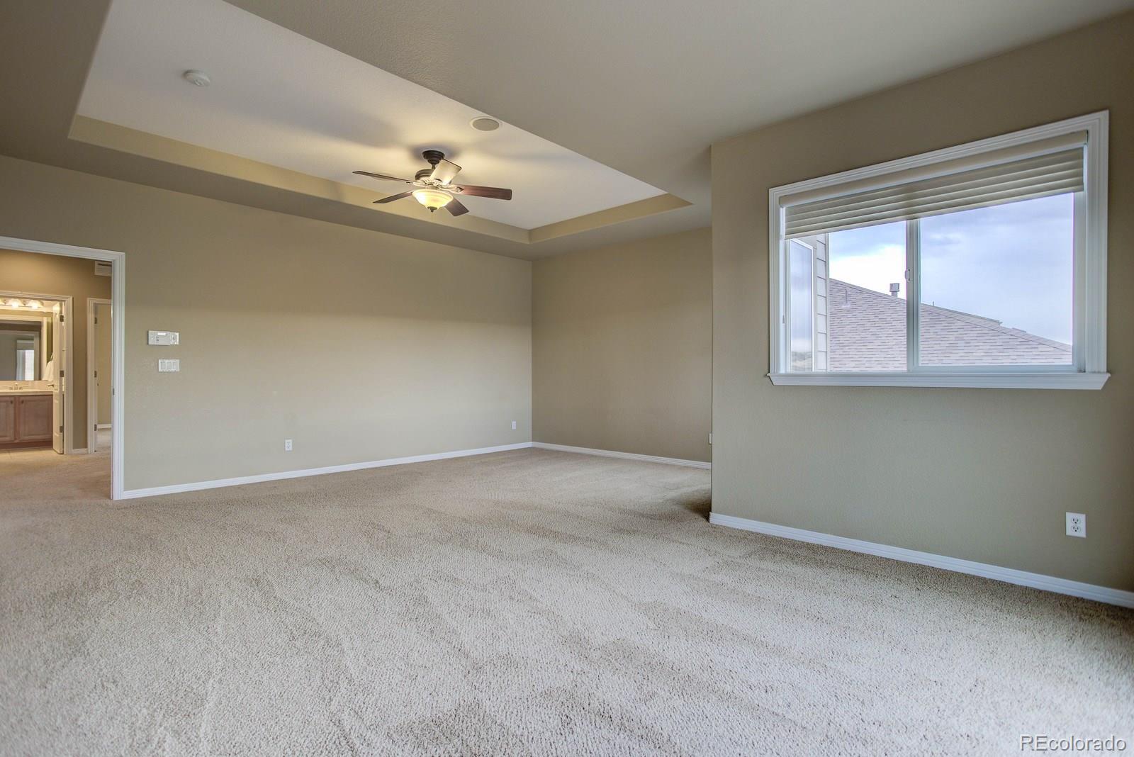 10879 Glengate Circle Highlands Ranch, CO 80130 - Photo 22 of 35 an empty room with windows and fan