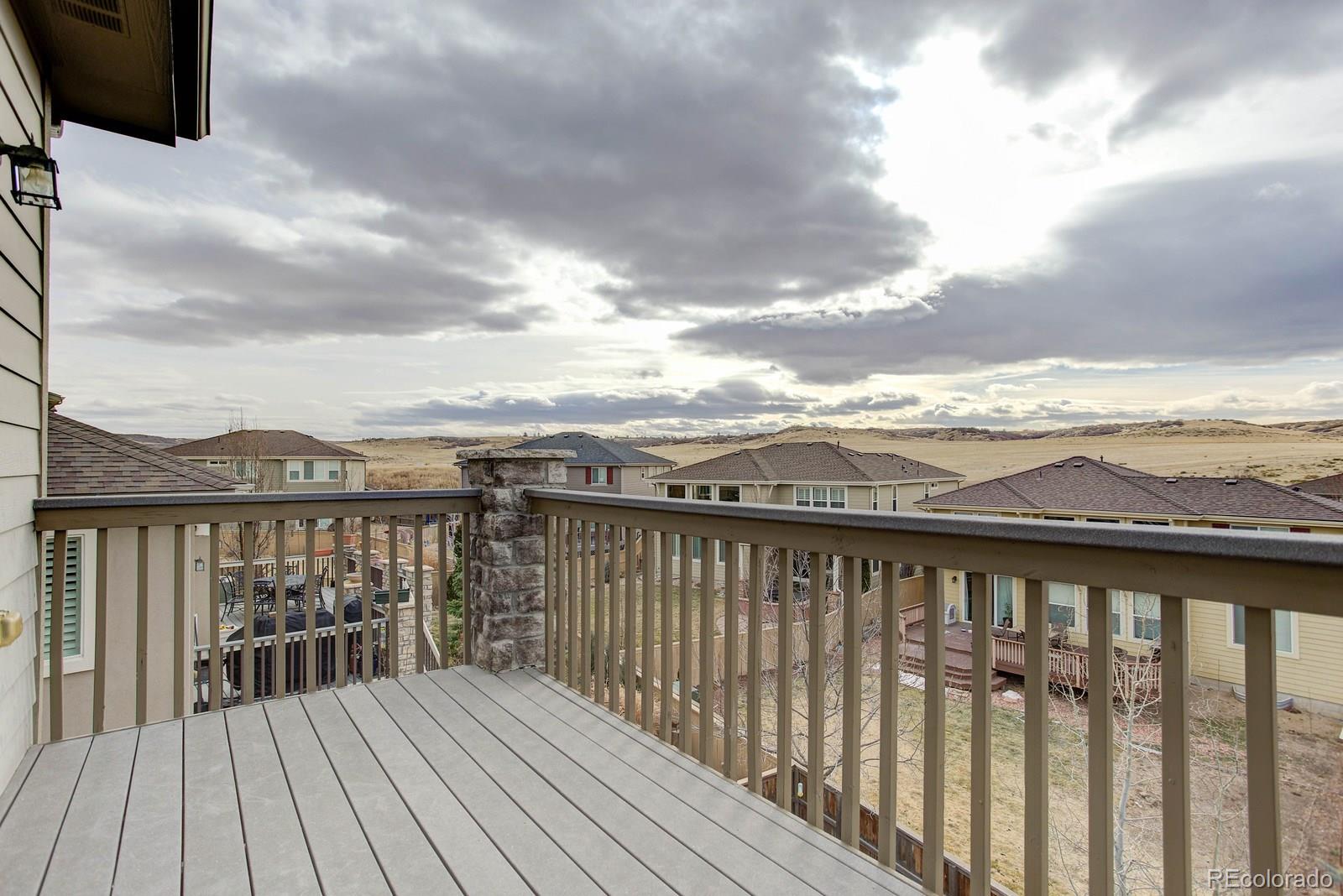 10879 Glengate Circle Highlands Ranch, CO 80130 - Photo 25 of 35 a view of a roof deck with wooden floor and fence
