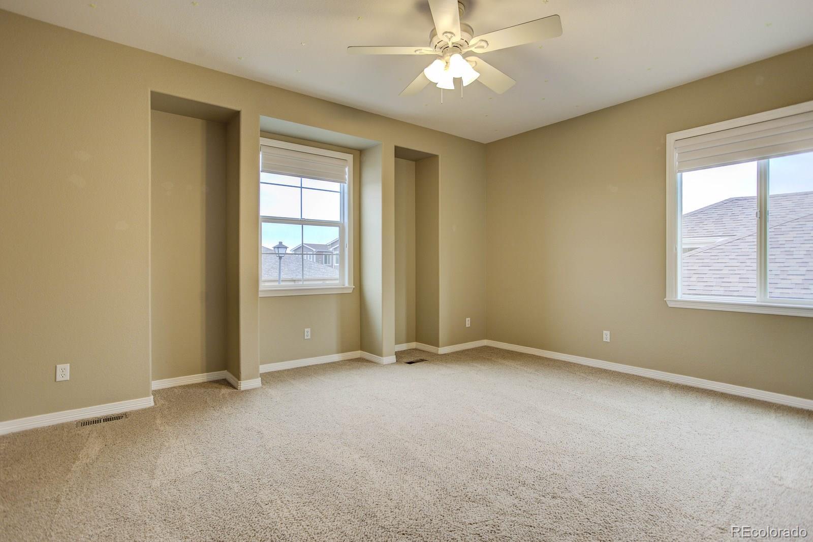 10879 Glengate Circle Highlands Ranch, CO 80130 - Photo 29 of 35 an empty room with windows and fan
