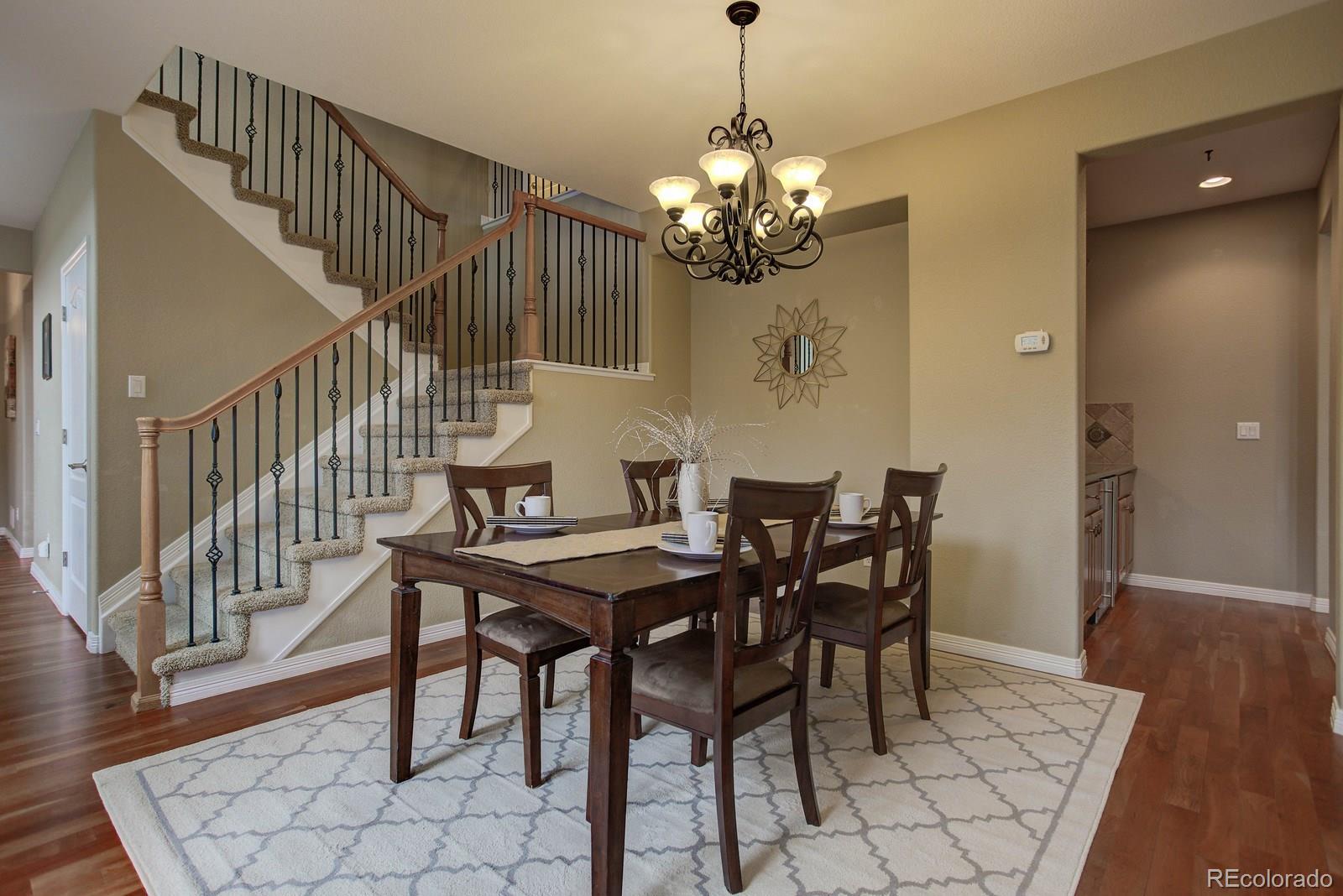10879 Glengate Circle Highlands Ranch, CO 80130 - Photo 7 of 35 a view of a dining room with furniture and wooden floor