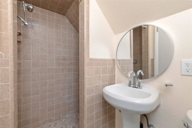 a bathroom with a sink a mirror and a light fixture
