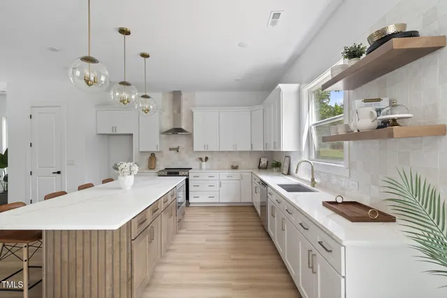 a kitchen with cabinets a sink and white appliances