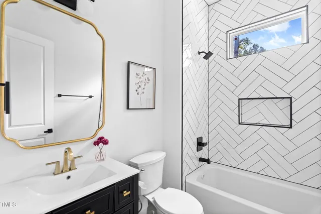a bathroom with a sink mirror vanity and toilet