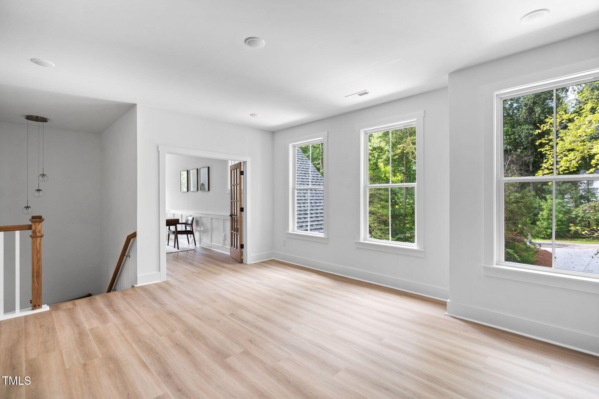 712 Oaks Lane Road Timberlake, NC 27583 - Photo 22 of 47 a view of an empty room with wooden floor and a window