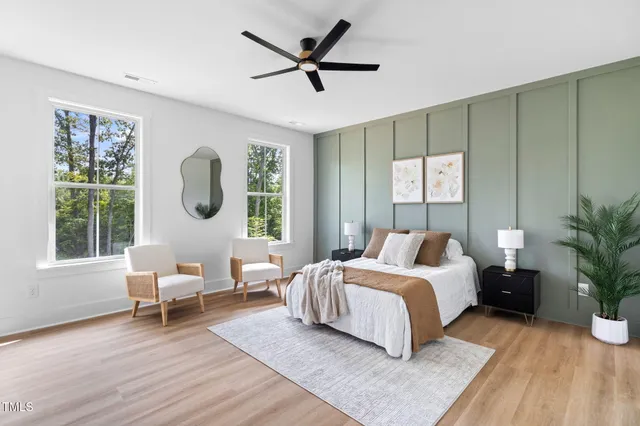 a living room with a bed furniture and a window